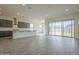 Bright and open living area with sliding glass doors and a modern kitchen in the background at 262 S 164Th Dr, Goodyear, AZ 85338