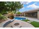 Gorgeous backyard oasis with a pool, spa, fire pit, and lush greenery, creating a perfect outdoor retreat at 26264 N 46Th St, Phoenix, AZ 85050