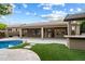 Expansive backyard featuring a covered patio, artificial turf, and a pool view, ideal for relaxation and entertainment at 26264 N 46Th St, Phoenix, AZ 85050