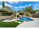 Stunning backyard featuring a pool, spa, built-in fire pit, and lush landscaping for ultimate relaxation and enjoyment at 26264 N 46Th St, Phoenix, AZ 85050