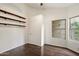 Bright bedroom with hardwood floors and decorative wood shelving at 26264 N 46Th St, Phoenix, AZ 85050