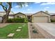 Charming single-story home with well-maintained landscaping, stone pathway, and attached two-car garage at 26264 N 46Th St, Phoenix, AZ 85050