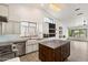 Bright kitchen with white cabinetry, stainless steel appliances, center island and modern lighting at 26264 N 46Th St, Phoenix, AZ 85050