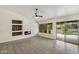 Elegant living room with a modern fireplace, ceiling fan and a sliding door to the backyard at 26264 N 46Th St, Phoenix, AZ 85050