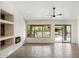 Modern living room showcasing a fireplace, recessed lighting, ceiling fan and access to backyard at 26264 N 46Th St, Phoenix, AZ 85050