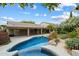 Inviting backyard pool and spa with mature landscaping, covered patio, and BBQ area for outdoor entertaining at 26264 N 46Th St, Phoenix, AZ 85050