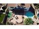 Aerial view of backyard oasis with patio, pool, putting green, and covered patio at 2712 W Oakgrove Ln, Chandler, AZ 85224