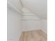 Well-lit attic space with built-in storage shelves and light wood flooring at 2712 W Oakgrove Ln, Chandler, AZ 85224