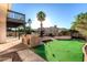 Beautiful backyard with a built-in grill, mature landscaping and an artificial putting green at 2712 W Oakgrove Ln, Chandler, AZ 85224