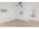 Bright bedroom featuring wood floors, ceiling fan and a large window at 2712 W Oakgrove Ln, Chandler, AZ 85224
