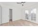 Bright bedroom featuring wood floors, ceiling fan, closet and french doors leading to the outside at 2712 W Oakgrove Ln, Chandler, AZ 85224