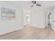 Bright bedroom featuring wood floors, ceiling fan, artwork and white trim at 2712 W Oakgrove Ln, Chandler, AZ 85224
