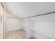Large closet with wood hanging rods and shelves providing ample storage space at 2712 W Oakgrove Ln, Chandler, AZ 85224