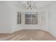 Well-lit dining area features natural light, white shutters, and a chandelier at 2712 W Oakgrove Ln, Chandler, AZ 85224