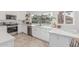Well-lit kitchen featuring stainless appliances, white cabinets, and outdoor view at 2712 W Oakgrove Ln, Chandler, AZ 85224