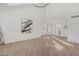 Open-concept living room with neutral carpet, bright natural light, and modern chandelier at 2712 W Oakgrove Ln, Chandler, AZ 85224