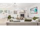 Bright living room boasts a fireplace, modern lighting, and a neutral-toned sectional sofa for cozy living at 2712 W Oakgrove Ln, Chandler, AZ 85224
