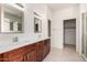 Bathroom with double sinks, wood cabinetry, and access to the shower at 2732 E Tyson St, Chandler, AZ 85225