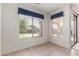 A neutral colored bedroom features tile floors, a large window and neutral paint at 2732 E Tyson St, Chandler, AZ 85225