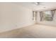 A spacious carpeted bedroom is brightened by natural light from the windows with curtains at 2732 E Tyson St, Chandler, AZ 85225