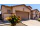 The tan home has a two car garage with a neat garden in front with low water use at 2732 E Tyson St, Chandler, AZ 85225