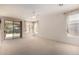 Bright living room boasts neutral paint, white trim, large windows, and sliding glass door at 2732 E Tyson St, Chandler, AZ 85225