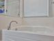 Relaxing soaking tub with chrome faucet and window with blinds at 30263 W Crittenden Ln, Buckeye, AZ 85396