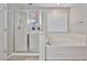 Bright bathroom featuring a glass-enclosed shower, soaking tub, and neutral tones at 30263 W Crittenden Ln, Buckeye, AZ 85396