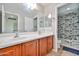 Bathroom features dual sinks, wood cabinets, and a separate door to the toilet and shower-tub at 30263 W Crittenden Ln, Buckeye, AZ 85396