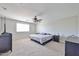 Spacious carpeted bedroom with ceiling fan, window and dresser at 30263 W Crittenden Ln, Buckeye, AZ 85396