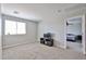 Spacious carpeted bedroom features a window and tv at 30263 W Crittenden Ln, Buckeye, AZ 85396
