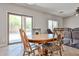 Inviting dining area with a round wooden table, decorative chairs, and sliding glass doors to the backyard at 30263 W Crittenden Ln, Buckeye, AZ 85396