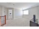 Upstairs hallway with gray walls and carpet with access to two bedrooms at 30263 W Crittenden Ln, Buckeye, AZ 85396