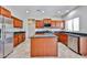 Kitchen featuring an island, granite counters, stainless steel appliances and wood cabinetry at 30263 W Crittenden Ln, Buckeye, AZ 85396