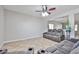 Living area displaying neutral-toned recliner couches and a tiled floor at 30263 W Crittenden Ln, Buckeye, AZ 85396