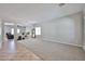 Spacious living room with tiled floors, neutral walls, an accent rug, and an adjacent den at 30263 W Crittenden Ln, Buckeye, AZ 85396