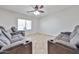 Home theatre showcasing luxurious seating, a ceiling fan, and large window at 30263 W Crittenden Ln, Buckeye, AZ 85396