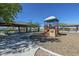 Community park with shaded picnic areas and playground equipment at 30263 W Crittenden Ln, Buckeye, AZ 85396