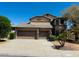 Two-story home featuring a two-car garage, mature landscaping, and a covered porch at 3502 W Belle Ave, San Tan Valley, AZ 85144