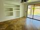 Bright living room with tile flooring, large sliding glass doors, and built in shelves at 3502 W Belle Ave, San Tan Valley, AZ 85144
