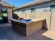 Outdoor kitchen with stone counter and built-in grill, surrounded by a brick-paved patio at 3502 W Belle Ave, San Tan Valley, AZ 85144