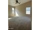 Spacious bedroom with carpeted floors, high ceilings, and natural light from two windows at 3633 E Potter Dr, Phoenix, AZ 85050