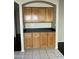 Dining area featuring wood cabinets, a black countertop, and tile flooring at 3633 E Potter Dr, Phoenix, AZ 85050