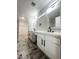 Bathroom featuring double vanity with quartz countertop, black fixtures, herringbone tile, and multiple mirrors at 37061 W Bello Ln, Maricopa, AZ 85138