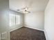 Small bedroom with carpet, a window, and a ceiling fan, creating a cozy and inviting atmosphere at 37061 W Bello Ln, Maricopa, AZ 85138