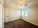 Cozy bedroom featuring carpet, window, and ceiling fan providing additional lighting and comfort at 37061 W Bello Ln, Maricopa, AZ 85138