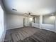 Spacious bonus room featuring neutral walls, carpet flooring, and a ceiling fan for added comfort at 37061 W Bello Ln, Maricopa, AZ 85138
