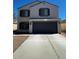 Charming two-story home with a driveway leading to an attached garage at 37061 W Bello Ln, Maricopa, AZ 85138