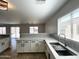 Bright kitchen features a stainless steel sink, light countertops and subway tile backsplash at 37061 W Bello Ln, Maricopa, AZ 85138