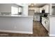 Spacious kitchen with stainless steel appliances, white cabinets, and light countertops at 37061 W Bello Ln, Maricopa, AZ 85138